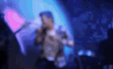 a blurry picture of a man singing into a microphone in a dark room