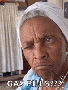 an elderly woman is making a funny face with the words gas pills below her