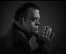 a black and white photo of a man with down syndrome in a suit and tie