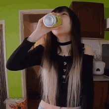 a woman drinking from a can that says lucky on the front