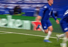 a soccer player in a blue jersey with the number 8 on it is running on the field
