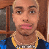 a man making a funny face with the word symmetry on the bottom right