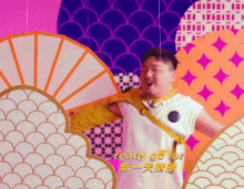 a man is dancing in front of a wall that says ready go for in chinese