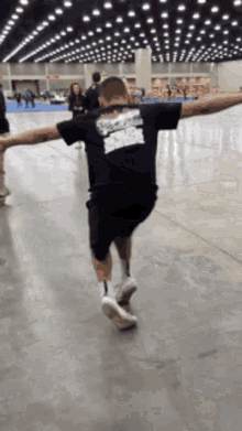 a man wearing a black shirt that says ' a ' on it