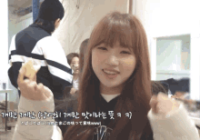 a girl with korean writing on her face is eating something