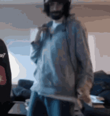 a blurry picture of a man wearing headphones and a sweatshirt that says cat on it