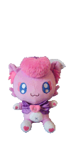 a pink stuffed animal wearing a purple cape and hat