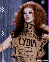 a woman with red hair is wearing a shirt that says lydia on it