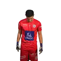 a man wearing a red shirt with the word uniqa on it
