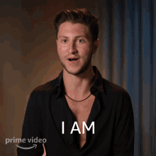 a man says " i am " in front of a prime video logo