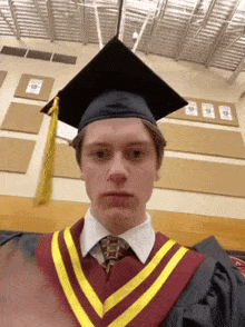 a young man in a graduation cap and gown