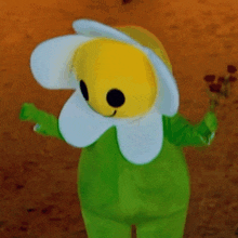 a yellow and white flower mascot with black eyes