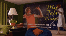 a poster for my fair evie hangs in a living room