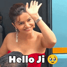 a woman in a red dress is waving her hand and the words hello ji are below her