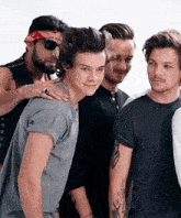 a group of men are posing for a picture together . one of the men has a bandana on his head .