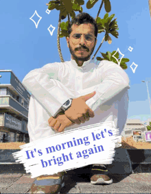 a man sits on a curb with a sign that says " it 's morning let 's bright again " on it