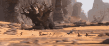 a group of people are running in the desert near a tree