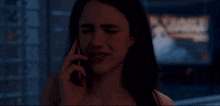 a woman is crying while talking on her phone