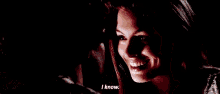 a woman is smiling and saying i know .
