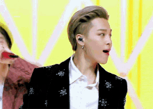 a close up of a man wearing earphones and a jacket