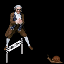 a man in a costume stands in front of a finish line sign