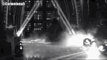 a black and white photo of a stage with the hashtag carmelona5 on the bottom