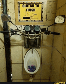 a urinal with a motorcycle handlebar and a sign that says clutch to flush