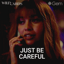 a woman is talking on a cell phone and the words just be careful are above her