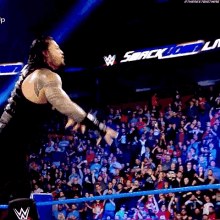 a man is jumping over a blue rope in front of a crowd .