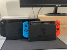 two nintendo switches are sitting next to each other on a mouse pad