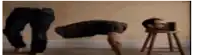 a man is doing push ups on the floor next to a stool with his head on it .