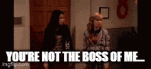 two girls standing next to each other with the words " you 're not the boss of me " on the bottom
