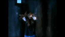a woman is standing in a dark room with her arms outstretched