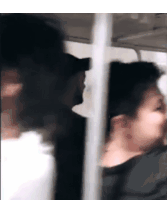 a blurry picture of a man and woman on a bus .