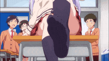 a girl with purple hair is sitting at a desk with her feet up