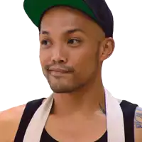 a man wearing a black hat and a white apron has a tattoo on his shoulder