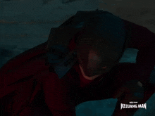a man in a superhero costume with the words keluarga man on the bottom right