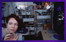 a woman stands in front of a shelf with a box that says n7