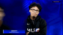 a man wearing glasses and a hoodie that says jgravity