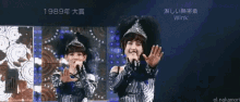 a woman with a crown on her head singing into a microphone with the year 1989 on the bottom right