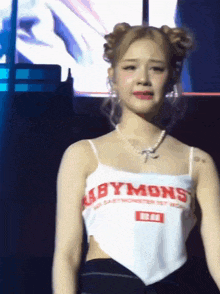 a woman wearing a white abby mons tank top