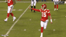 a football player with the number 15 on his jersey is pointing