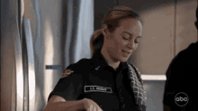 a woman in a firefighter uniform has the name l.t. wilson on her chest