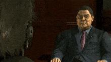 a man in a suit and tie holds his hands together