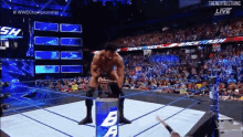 a man in a wrestling ring with a barrel that says ba on it