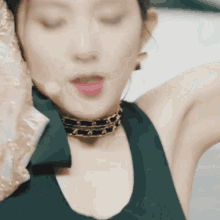 a close up of a woman wearing a choker necklace and earrings