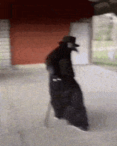 a person in a plague doctor costume is walking down a sidewalk