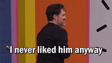 a man says i never liked him anyway in front of a rainbow wall