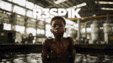 a boy is standing in a body of water with the words r3spik above him