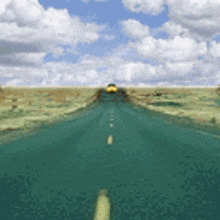 a yellow car is driving down a green highway